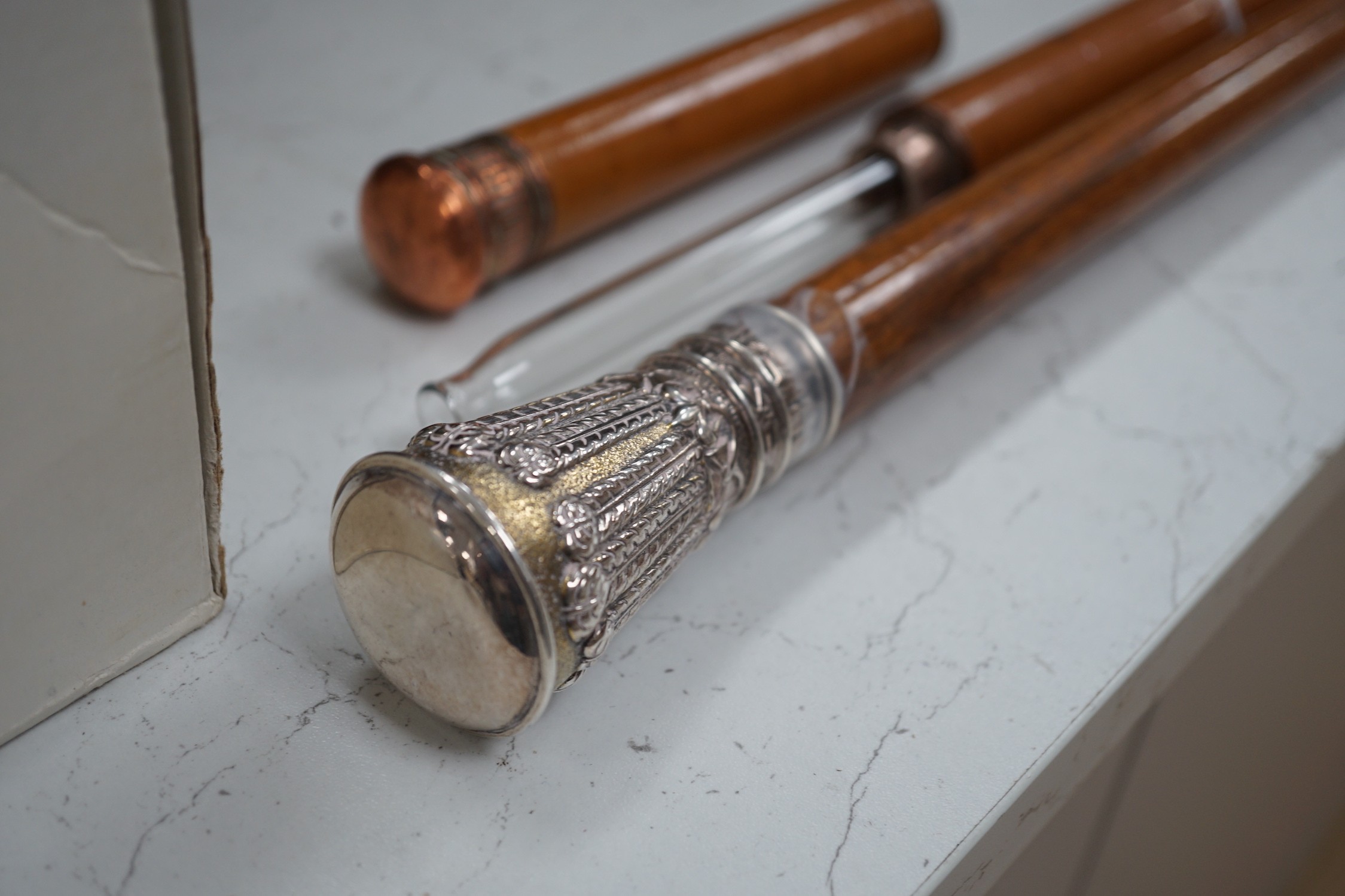 A silver handled cane win a horn tip and a copper handled flask cane, silver handled cane 94 cms long